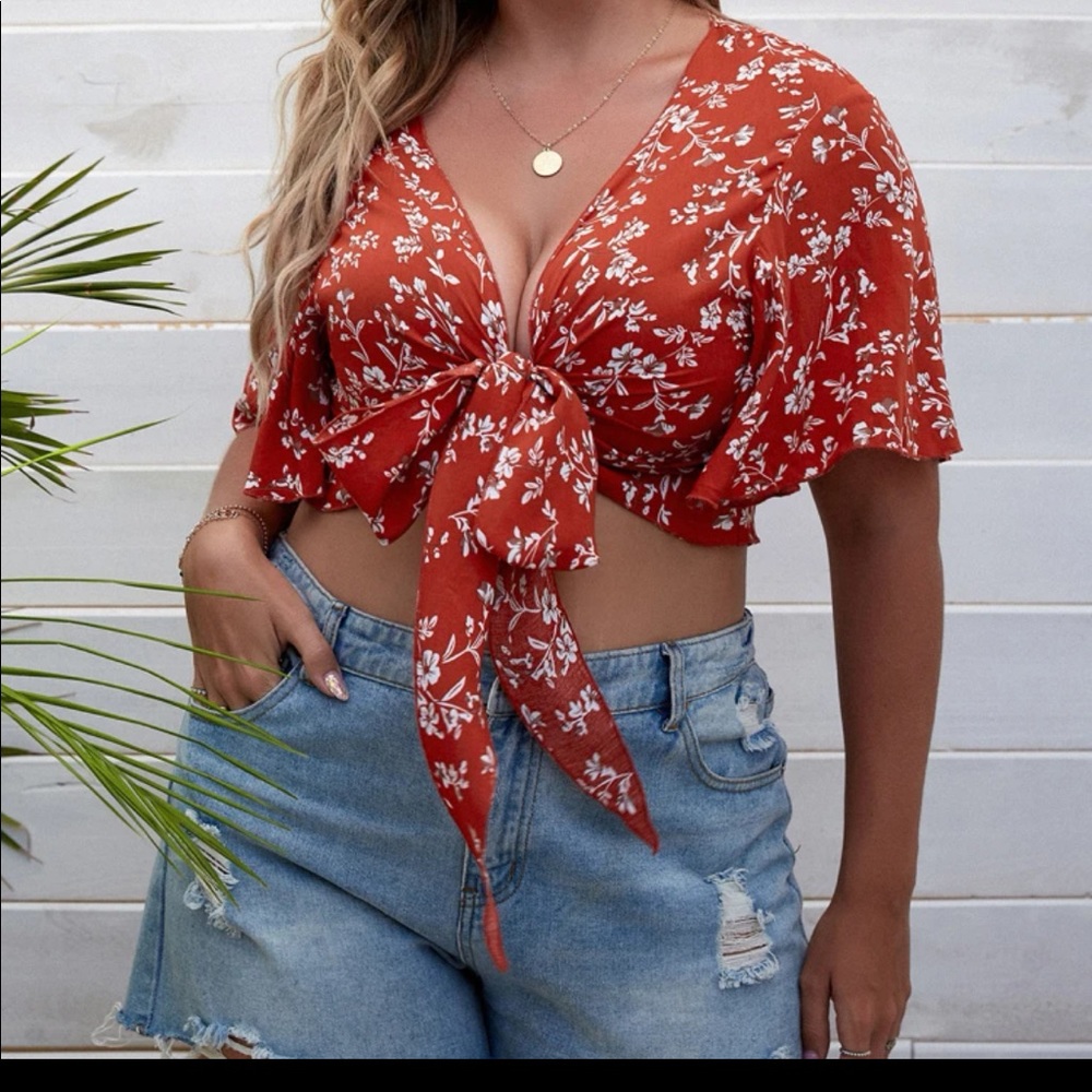 Reddish brown crop top with white flowers/leaves